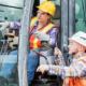construction site safety Costa Rica workers using heavy machinery with protective gear and supervision