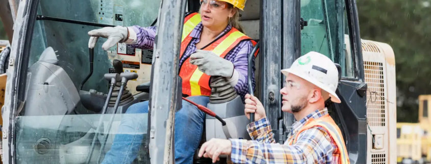 construction site safety Costa Rica workers using heavy machinery with protective gear and supervision